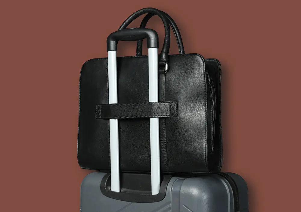 mayfair laptop bag - black leather laptop bag secured on top of a suitcase with trolley handle